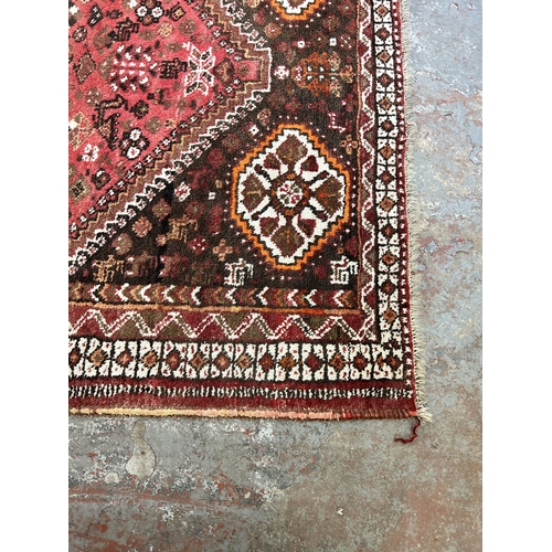 63 - A Persian style machine woven rug - approx. 252cm x 164cm