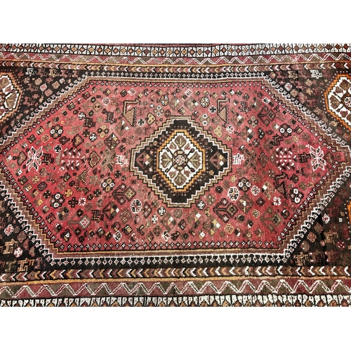 63 - A Persian style machine woven rug - approx. 252cm x 164cm