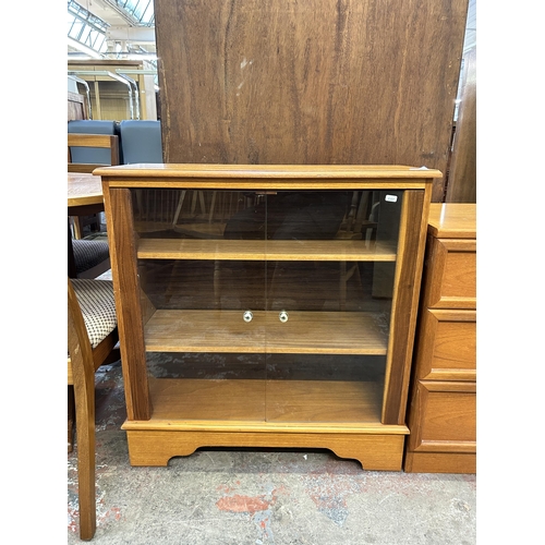 66 - A teak two door glazed display cabinet