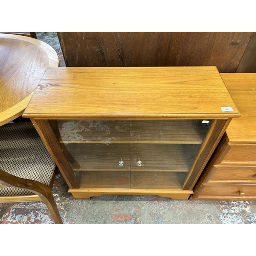 66 - A teak two door glazed display cabinet