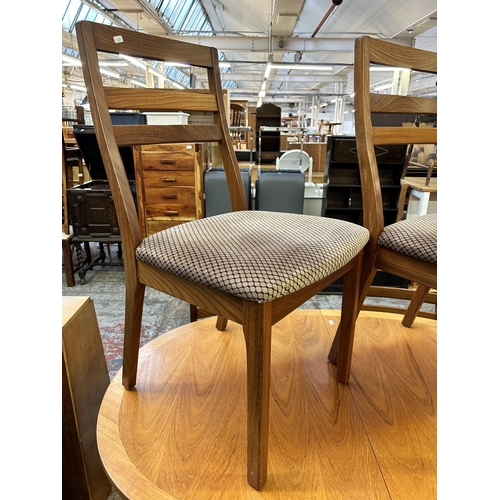 69 - A Nathan teak extending dining table and four chairs - approx. 74cm high x 91cm wide x 135cm long