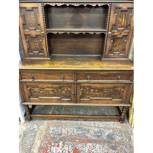 7 - A Jacobean style geometric carved oak dresser - approx. 190cm high x 152cm wide x 50cm deep