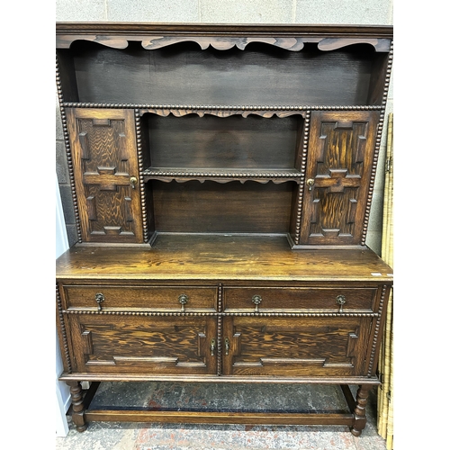 7 - A Jacobean style geometric carved oak dresser - approx. 190cm high x 152cm wide x 50cm deep