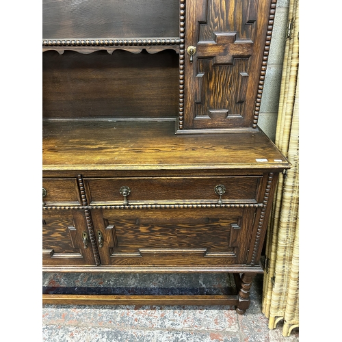 7 - A Jacobean style geometric carved oak dresser - approx. 190cm high x 152cm wide x 50cm deep