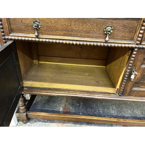 7 - A Jacobean style geometric carved oak dresser - approx. 190cm high x 152cm wide x 50cm deep