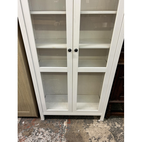 8 - An IKEA white painted display cabinet with two glazed doors - approx. 197cm high x 89cm wide x 37cm ... 