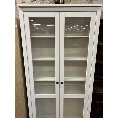 8 - An IKEA white painted display cabinet with two glazed doors - approx. 197cm high x 89cm wide x 37cm ... 