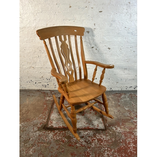 82 - A Victorian style solid beech farmhouse rocking chair