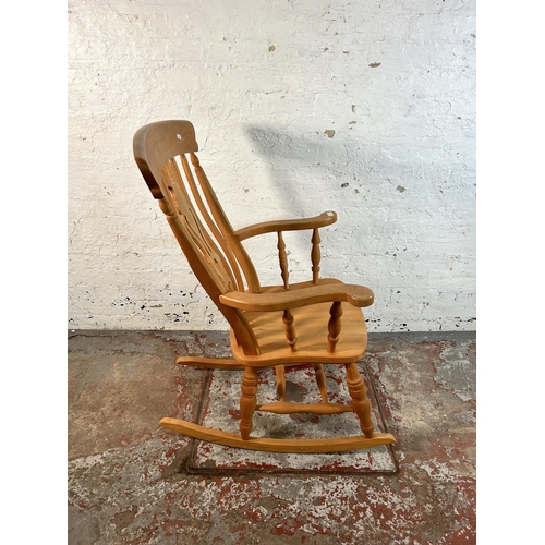 82 - A Victorian style solid beech farmhouse rocking chair