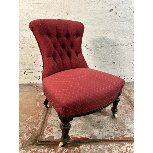 85A - A Victorian fabric upholstered button back nursing chair on turned mahogany supports and ceramic cas... 