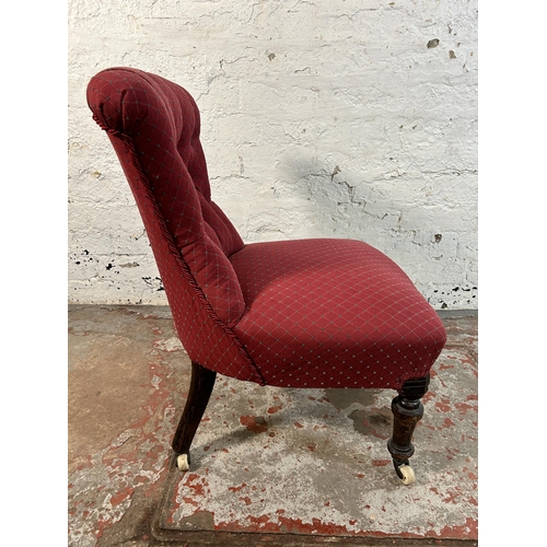 85A - A Victorian fabric upholstered button back nursing chair on turned mahogany supports and ceramic cas... 