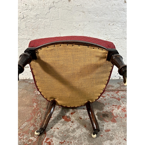 85A - A Victorian fabric upholstered button back nursing chair on turned mahogany supports and ceramic cas... 