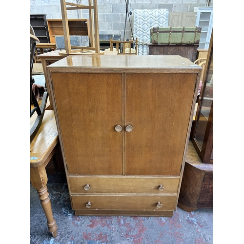 88 - A mid 20th century Vesper Furniture oak two door cabinet