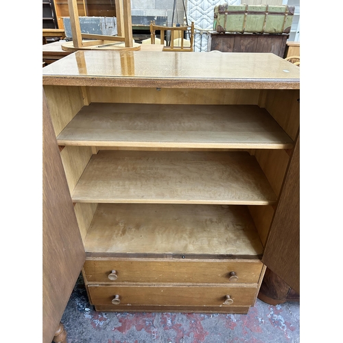 88 - A mid 20th century Vesper Furniture oak two door cabinet