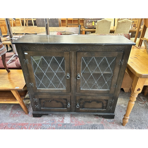 92 - A carved oak four door lead glazed bookcase