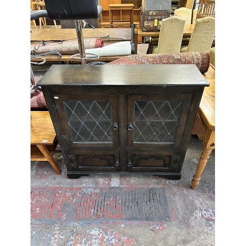 92 - A carved oak four door lead glazed bookcase