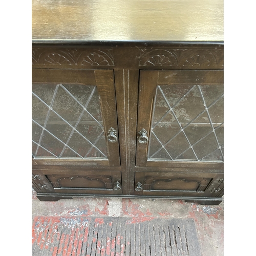 92 - A carved oak four door lead glazed bookcase