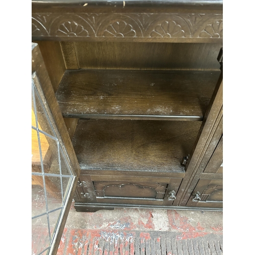 92 - A carved oak four door lead glazed bookcase