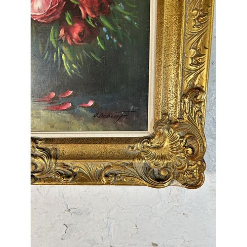 258 - A gilt framed floral still life oil on canvas signed A. Debeuf - approx. 88cm high x 67cm wide