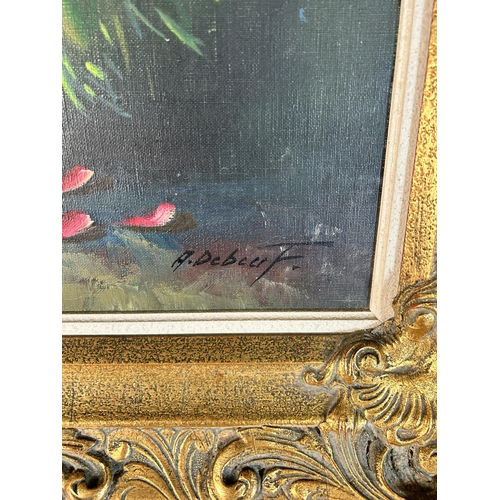 258 - A gilt framed floral still life oil on canvas signed A. Debeuf - approx. 88cm high x 67cm wide