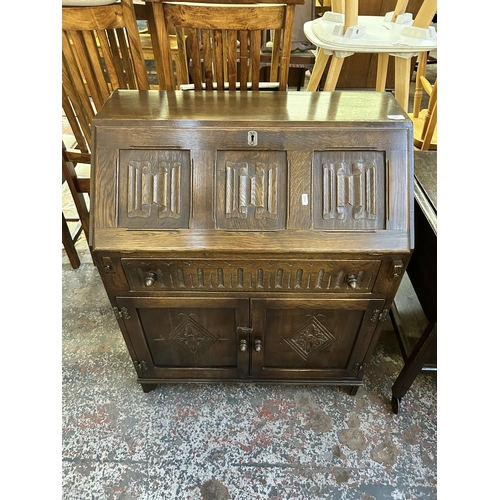 122 - A carved oak linenfold bureau - approx. 93cm high x 76cm wide x 42cm deep