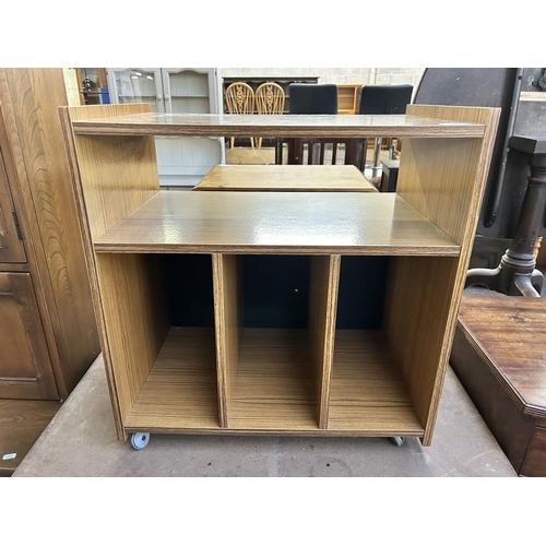 132 - A mid 20th century teak effect record cabinet on casters - approx. 61cm high x 58cm wide x 38cm deep