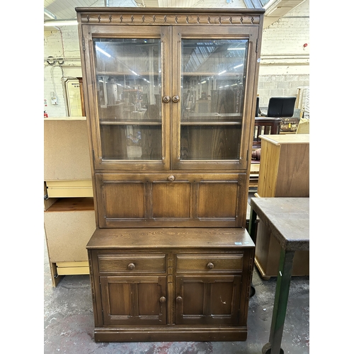 134 - An Ercol Golden Dawn elm bookcase