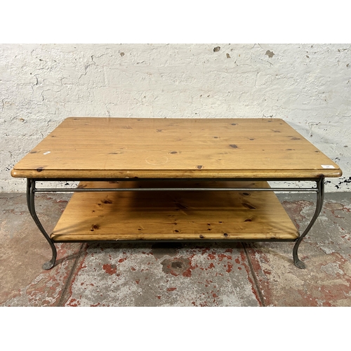 142 - A Ducal pine and wrought iron two tier coffee table