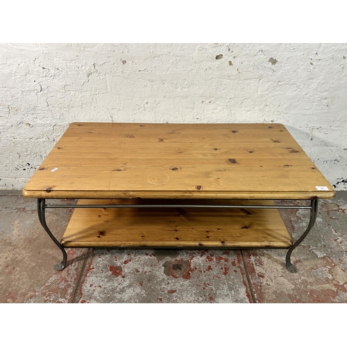 142 - A Ducal pine and wrought iron two tier coffee table