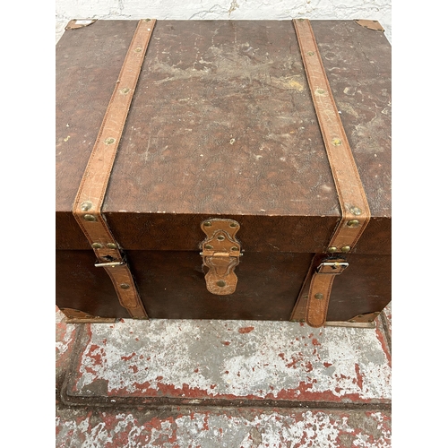 163 - An antique style brown faux leather travel trunk coffee table