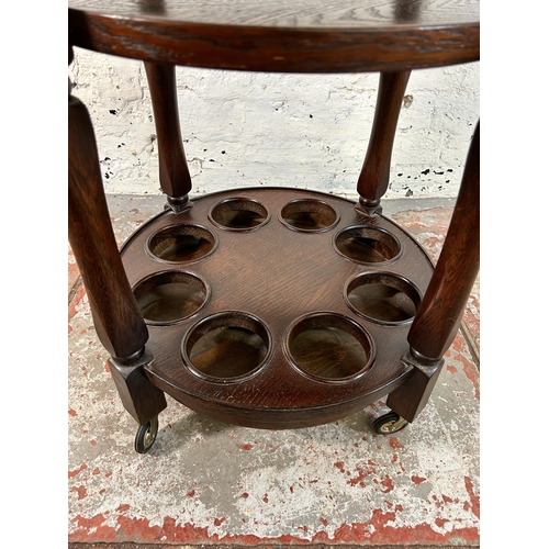 164 - An oak three tier drinks trolley - approx. 67cm high x 47cm diameter