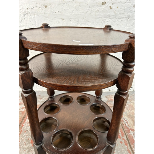 164 - An oak three tier drinks trolley - approx. 67cm high x 47cm diameter