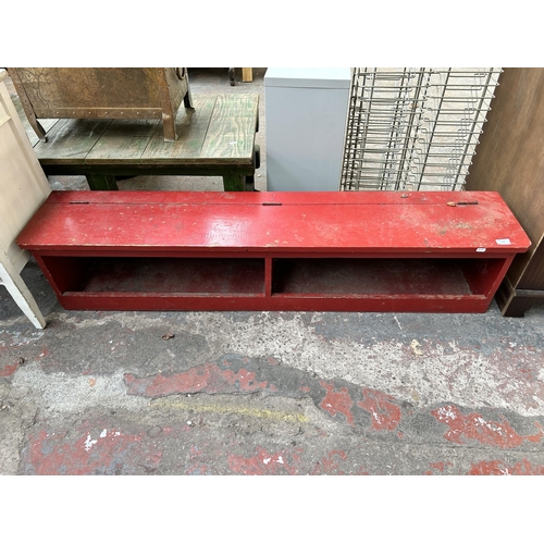 177 - A mid 20th century red painted wooden shoe bench - approx. 34cm high x 157cm wide x 30cm deep