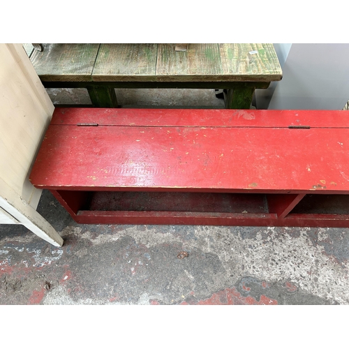 177 - A mid 20th century red painted wooden shoe bench - approx. 34cm high x 157cm wide x 30cm deep