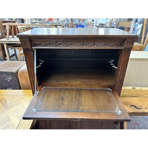 180 - A carved oak linenfold cocktail cabinet - approx. 123cm high x 80cm wide x 48cm deep