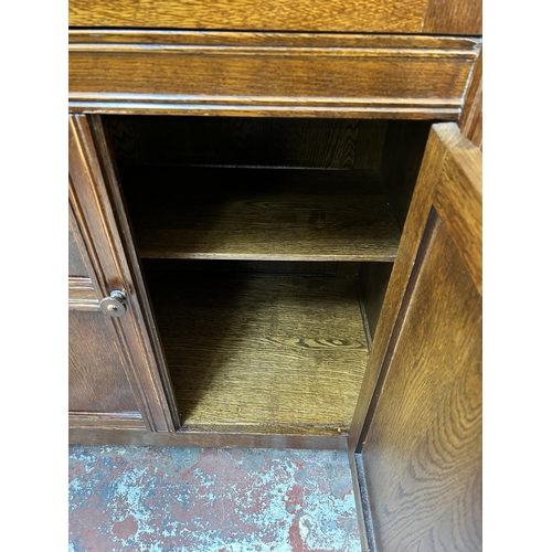 180 - A carved oak linenfold cocktail cabinet - approx. 123cm high x 80cm wide x 48cm deep