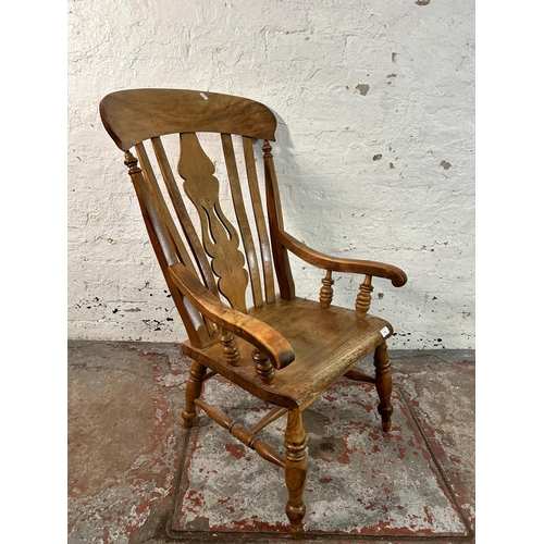 194 - A Victorian elm and beech farmhouse armchair