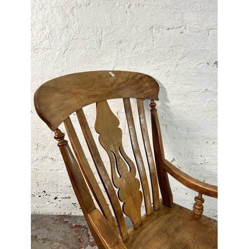 194 - A Victorian elm and beech farmhouse armchair