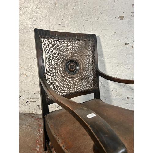 207 - A mid 20th century beech and brown leather rattan back bergere armchair