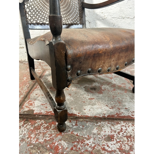 207 - A mid 20th century beech and brown leather rattan back bergere armchair