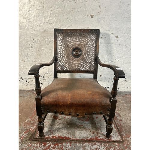 207 - A mid 20th century beech and brown leather rattan back bergere armchair