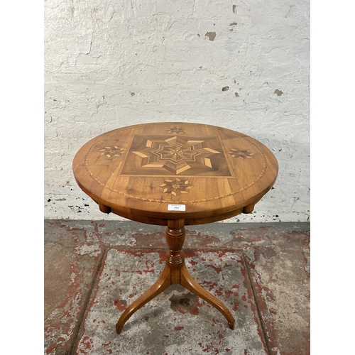 211 - A walnut and marquetry inlaid tripod occasional table - approx. 70cm high x 60cm diameter