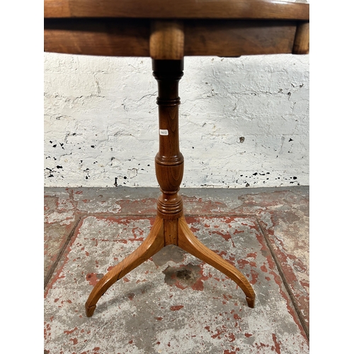 211 - A walnut and marquetry inlaid tripod occasional table - approx. 70cm high x 60cm diameter