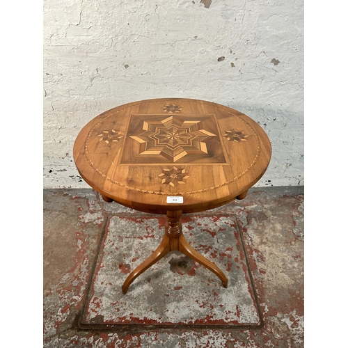 211 - A walnut and marquetry inlaid tripod occasional table - approx. 70cm high x 60cm diameter