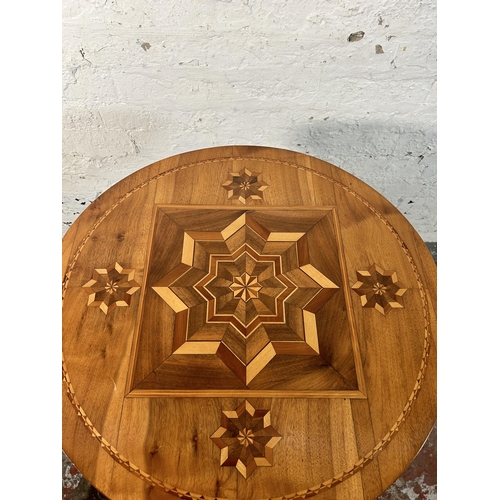 211 - A walnut and marquetry inlaid tripod occasional table - approx. 70cm high x 60cm diameter