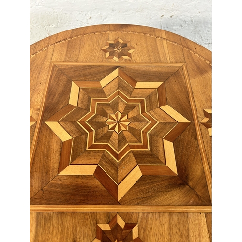 211 - A walnut and marquetry inlaid tripod occasional table - approx. 70cm high x 60cm diameter