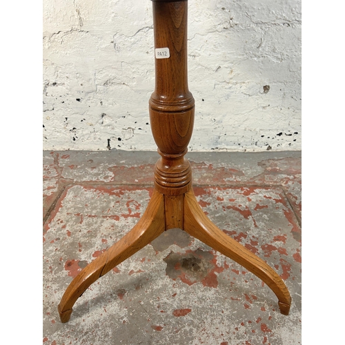 211 - A walnut and marquetry inlaid tripod occasional table - approx. 70cm high x 60cm diameter