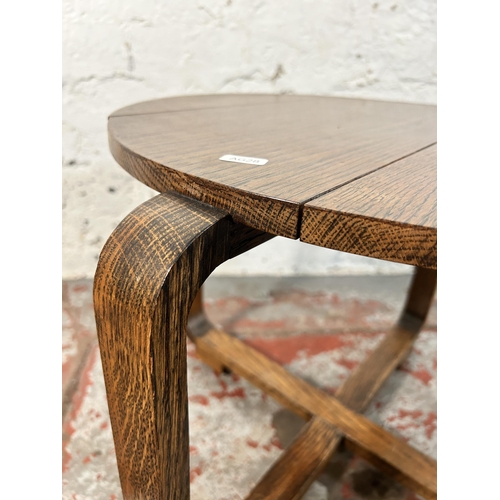 212 - An Art Deco oak side table - approx. 43cm high x 52cm diameter