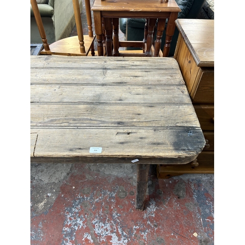 214 - An early 20th century pine trestle table - approx. 75cm high x 61cm wide x 243cm long