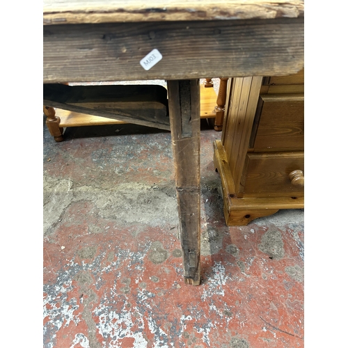 214 - An early 20th century pine trestle table - approx. 75cm high x 61cm wide x 243cm long